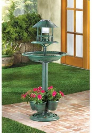 Three-in-one Solar Light Bird Bath and Planter Garden Centerpiece on patio with red flowers